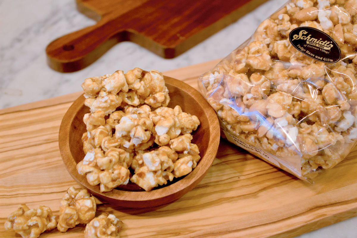 a bag and a bowl of buttery rich golden caramel popcorn