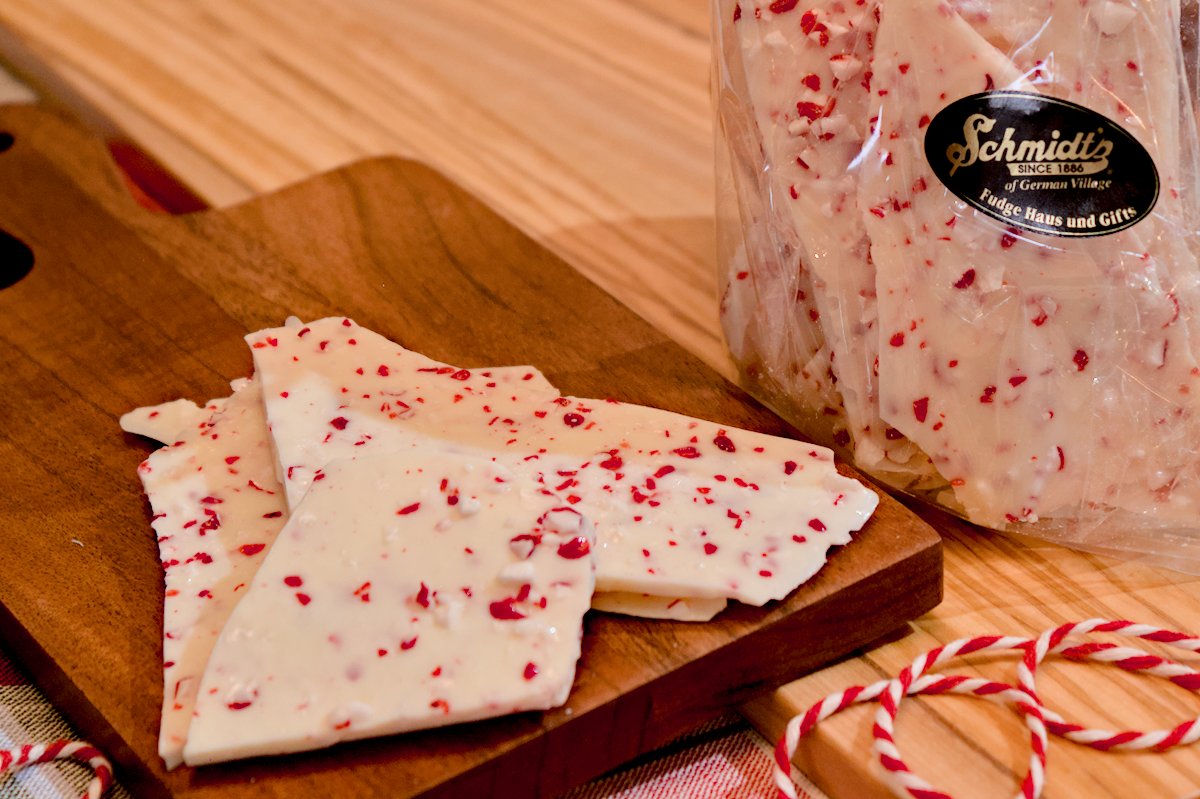 Peppermint bark on a dark colored wooden cutting board