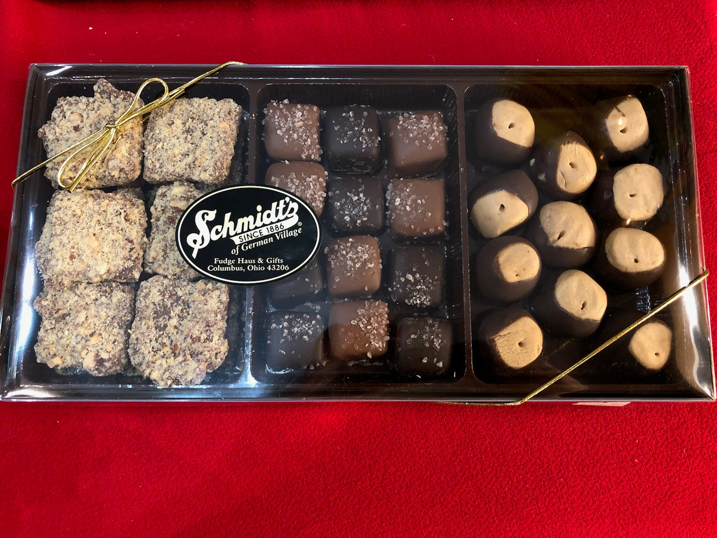 A box set of sweets containing handmade buckeyes, sea salt caramels, and butter almond crunch.