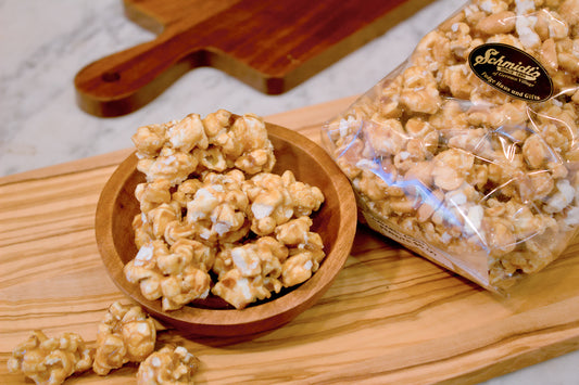 a bag and a bowl of buttery rich golden caramel popcorn